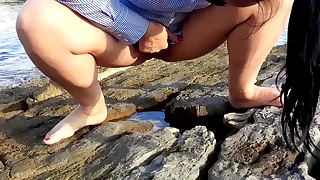 Wife pees open-air on the beach